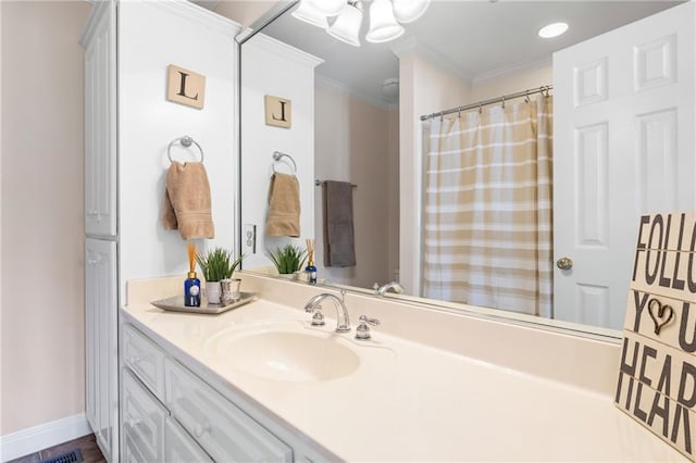 bathroom featuring crown molding and vanity