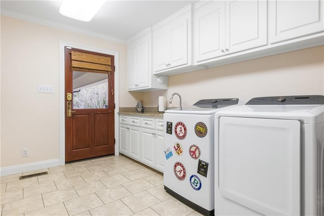 washroom with washer and clothes dryer, cabinets, light tile patterned floors, and crown molding