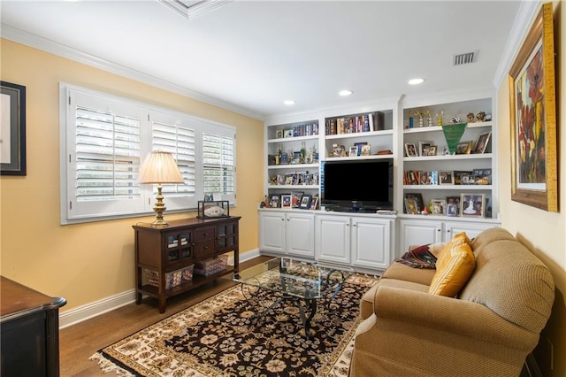 living room with dark hardwood / wood-style floors, built in features, and ornamental molding