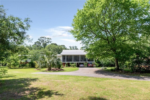 2100 River Forest Rd, Mobile, AL 36605 - view of green lawn with a sunroom and asphalt driveway