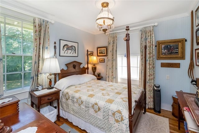 2100 River Forest Rd, Mobile, AL 36605 - bedroom featuring multiple windows, ornamental molding, a chandelier, and wood finished floors