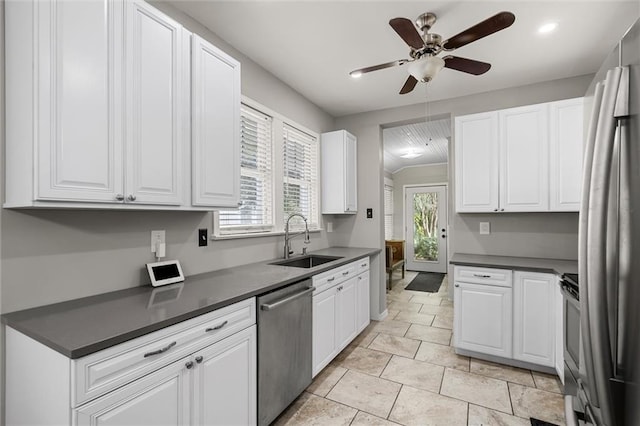 kitchen featuring sink, ceiling fan, light tile patterned floors, white cabinetry, and stainless steel appliances