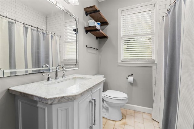 bathroom with a shower with shower curtain, vanity, toilet, and a wealth of natural light