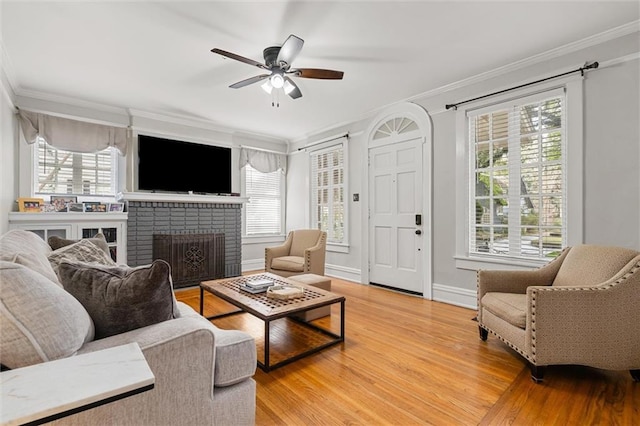 living room with hardwood / wood-style flooring, a healthy amount of sunlight, and ornamental molding