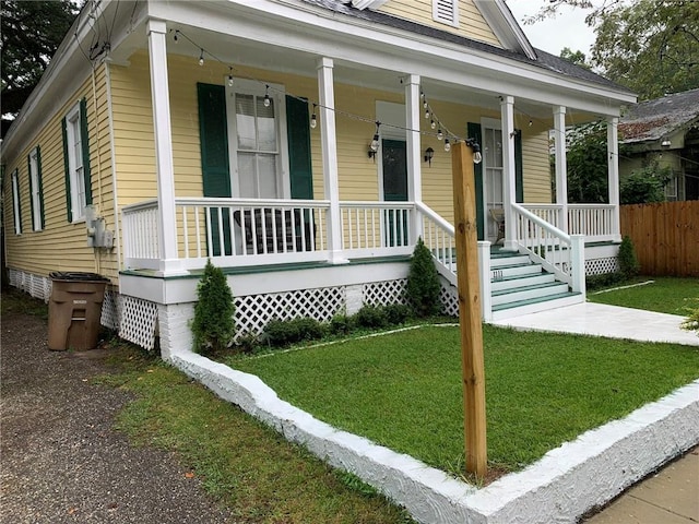 view of front of home with a porch and a front yard