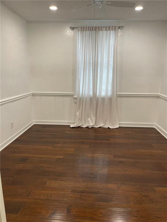 empty room with ceiling fan and dark wood-type flooring