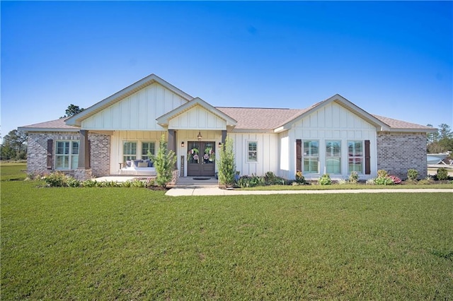 view of front of house with a front yard and a porch