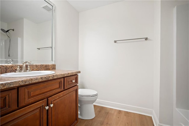 full bathroom featuring vanity, toilet, hardwood / wood-style flooring, and bathing tub / shower combination