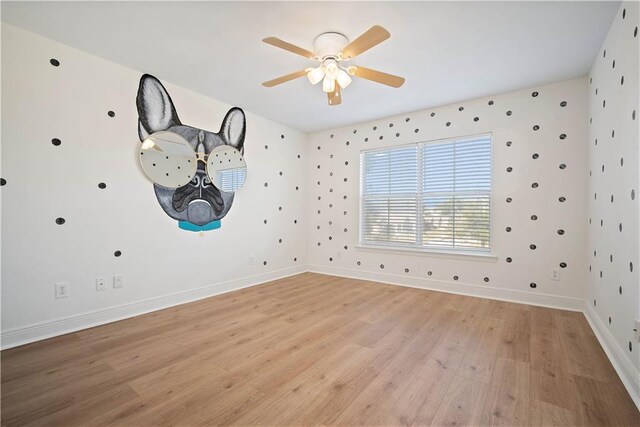 empty room featuring light wood-type flooring and ceiling fan