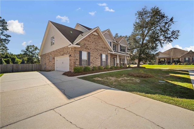 view of front of property with a front yard and a garage