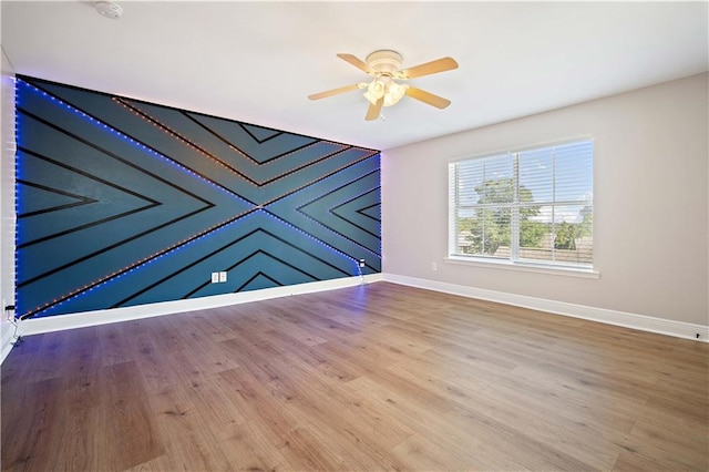 unfurnished room with wood-type flooring and ceiling fan