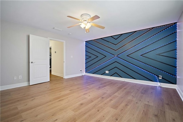 unfurnished room featuring ceiling fan and light hardwood / wood-style flooring