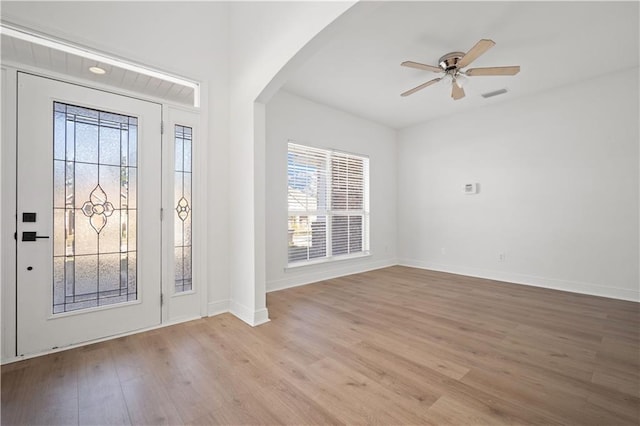 entrance foyer with a healthy amount of sunlight, light wood-type flooring, and ceiling fan