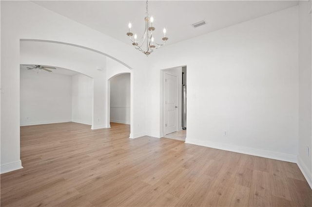 unfurnished room featuring light hardwood / wood-style floors and ceiling fan with notable chandelier