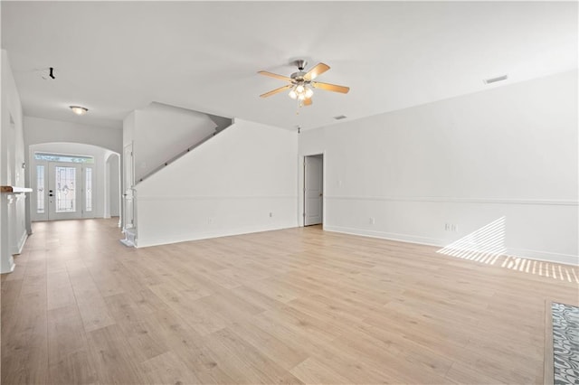 unfurnished living room with light wood-type flooring and ceiling fan