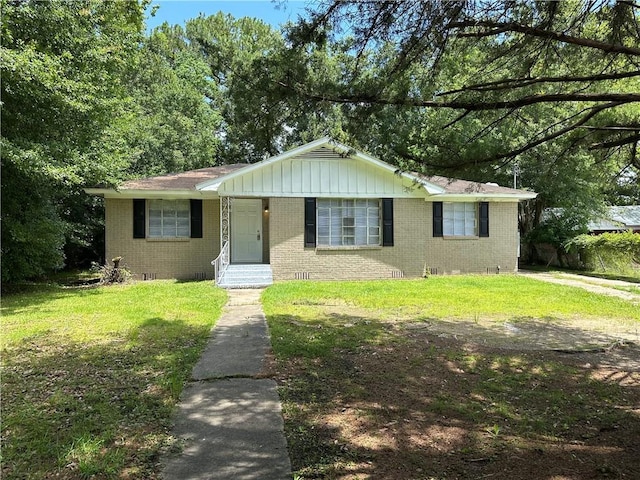 1820 N Barkley Dr, Mobile, AL 36606 - view of front of property with brick siding, a front yard, and board and batten siding