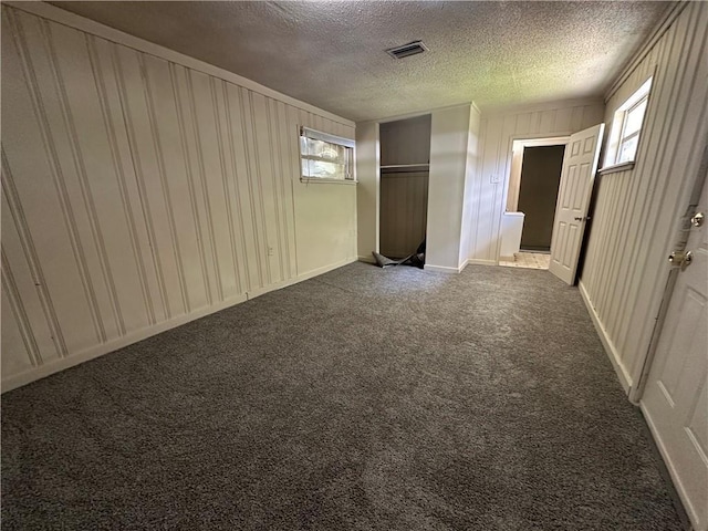 1820 N Barkley Dr, Mobile, AL 36606 - unfurnished bedroom featuring a textured ceiling, dark carpet, and a closet