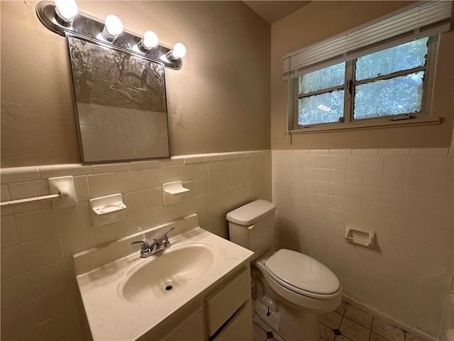 1820 N Barkley Dr, Mobile, AL 36606 - bathroom featuring tile walls, tile patterned flooring, wainscoting, and vanity