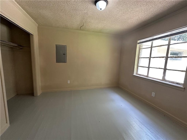 1820 N Barkley Dr, Mobile, AL 36606 - unfurnished bedroom featuring electric panel, a textured ceiling, multiple windows, wood finished floors, and a closet