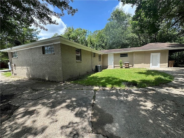 1820 N Barkley Dr, Mobile, AL 36606 - view of property exterior with brick siding and a yard