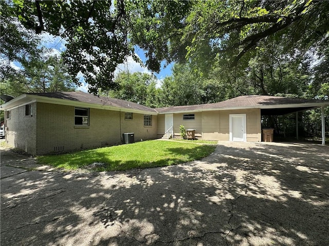 1820 N Barkley Dr, Mobile, AL 36606 - back of house featuring driveway, brick siding, a carport, a lawn, and entry steps