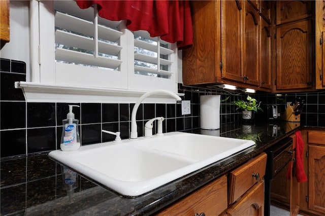 1337 Carson Rd W, Mobile, AL 36695 - kitchen featuring black dishwasher, brown cabinets, backsplash, and a sink