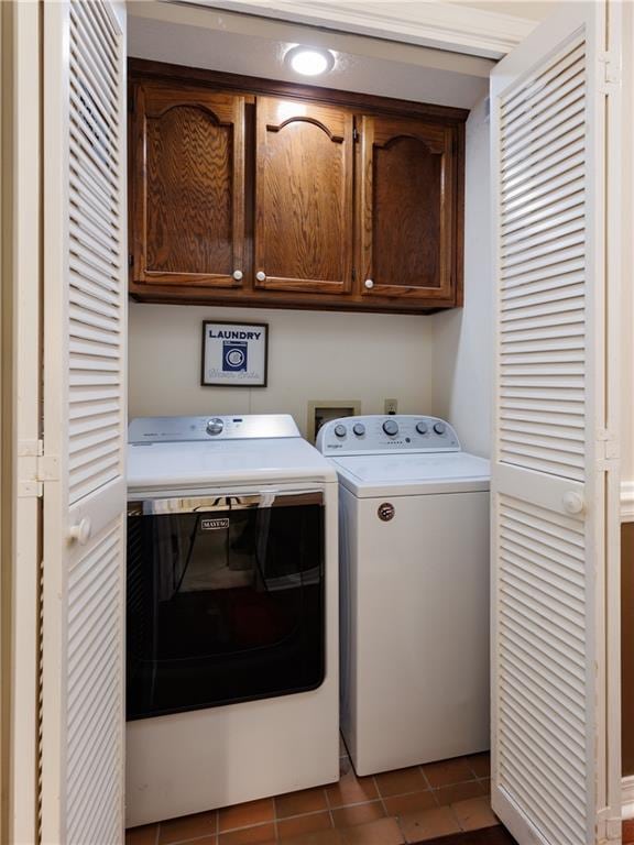 1337 Carson Rd W, Mobile, AL 36695 - laundry room with tile patterned floors, washer and dryer, and cabinet space