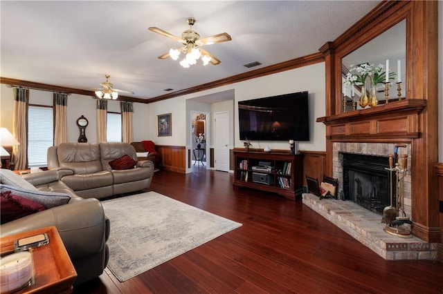 1337 Carson Rd W, Mobile, AL 36695 - living room featuring a brick fireplace, ceiling fan, crown molding, visible vents, and wood finished floors