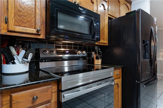 1337 Carson Rd W, Mobile, AL 36695 - kitchen featuring black appliances, tile patterned flooring, brown cabinets, and decorative backsplash