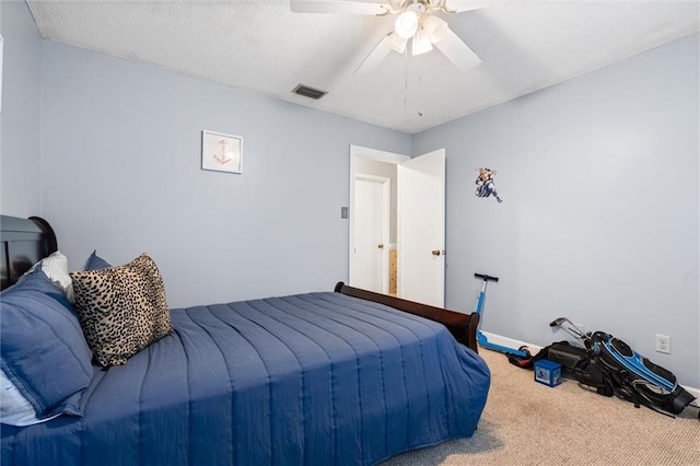 bedroom featuring a textured ceiling, carpet, and ceiling fan