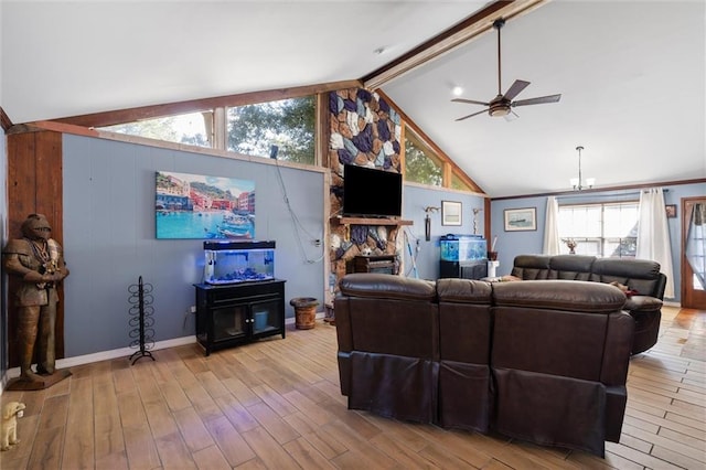 living room featuring vaulted ceiling with beams, light hardwood / wood-style flooring, a fireplace, and ceiling fan with notable chandelier