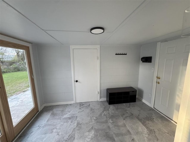 interior space featuring marble finish floor and concrete block wall