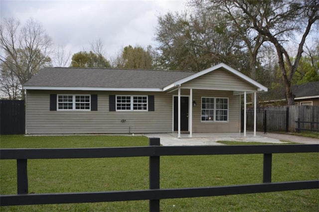 ranch-style house with a front yard, a patio, and fence