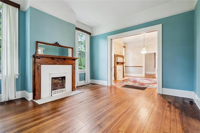 unfurnished living room featuring hardwood / wood-style flooring