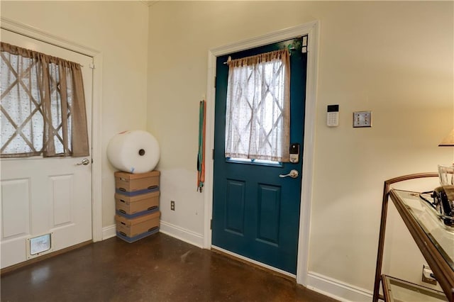 entryway with finished concrete flooring and baseboards