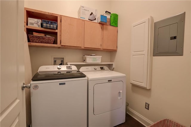 clothes washing area featuring washer and clothes dryer, electric panel, and cabinets