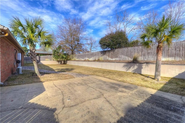 view of yard featuring a patio and a fenced backyard