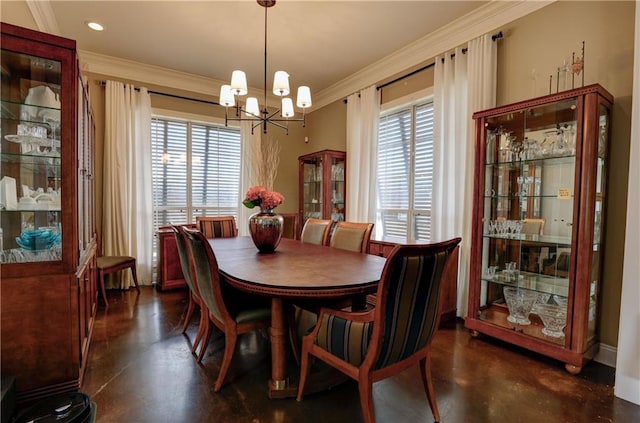 dining area featuring ornamental molding, a notable chandelier, a healthy amount of sunlight, and finished concrete floors