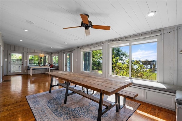 sunroom with lofted ceiling, wooden ceiling, and ceiling fan