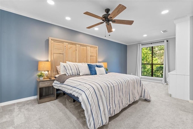 carpeted bedroom featuring crown molding and ceiling fan