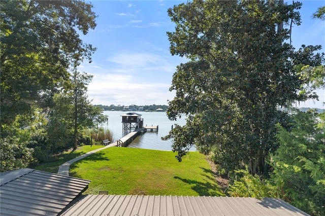 view of dock featuring a lawn and a water view