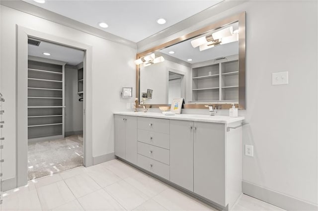 bathroom featuring built in shelves, vanity, and tile patterned flooring