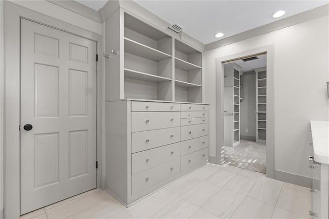 spacious closet featuring light tile patterned floors