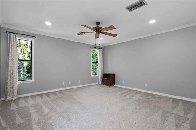 unfurnished room with ceiling fan, light carpet, and plenty of natural light