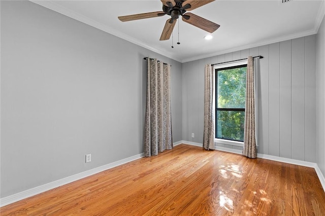 unfurnished room with ornamental molding, light wood-type flooring, and ceiling fan