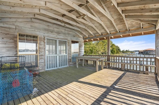 wooden terrace featuring a water view