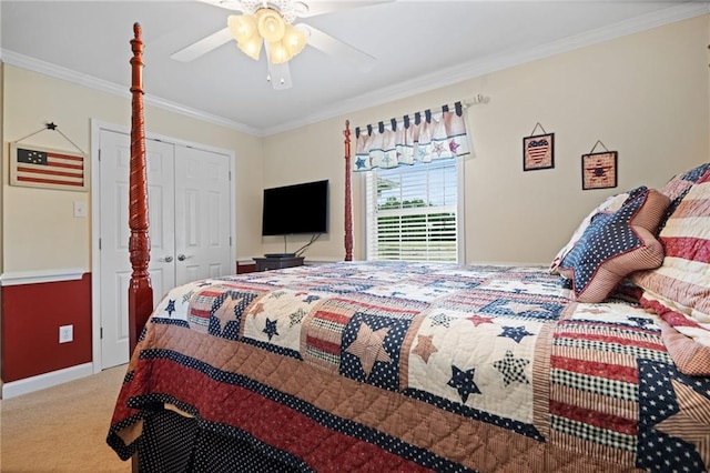 carpeted bedroom with a closet, ceiling fan, and crown molding