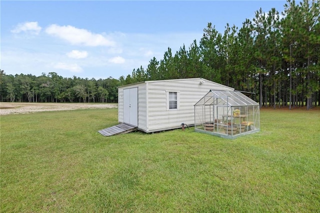 view of outbuilding featuring a yard