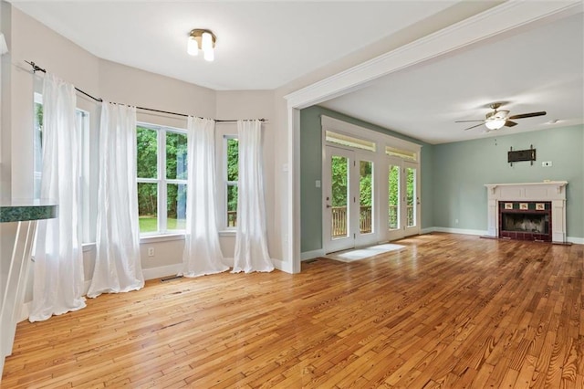 unfurnished living room featuring ceiling fan and light hardwood / wood-style floors