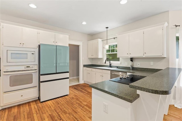 kitchen featuring white cabinetry, white appliances, and light hardwood / wood-style floors